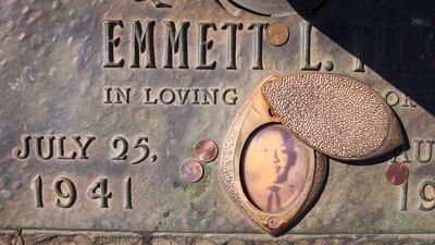 FILE PHOTO: A faded photograph is attached to the headstone that marks the gravesite of Emmett Till in Burr Oak Cemetery on March 22, 2021, in Chicago, Illinois.  (Photo by Scott Olson/Getty Images)